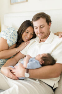 Long Island newborn photos. Parents looking at baby